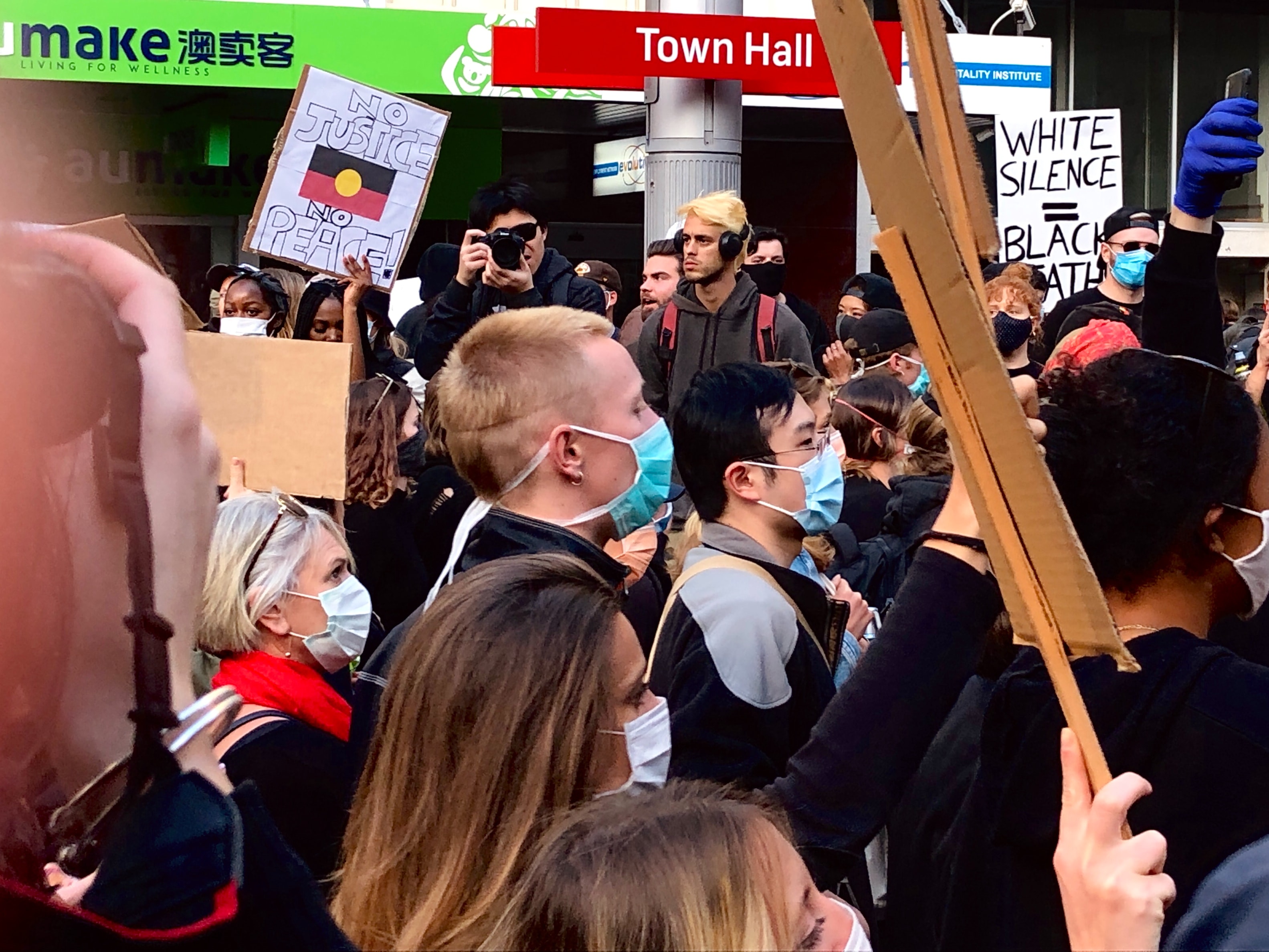 A crowd of masked protesters in Sydney to show solidarity for the Black Lives Matter movement and protesting aboriginal deaths in police custody.